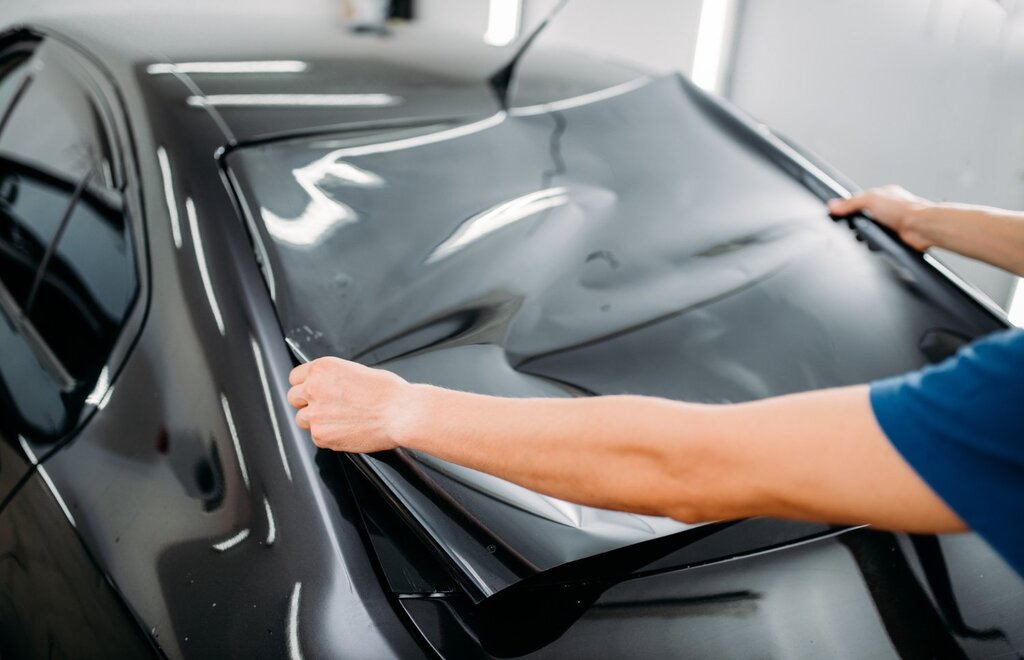 male-specialist-with-car-tinting-film-hands-installation-process-tinted-auto-glass-installing-procedure